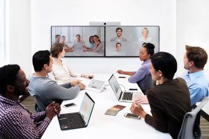 Cisco Video call with six people in a boardroom with a shared double screen