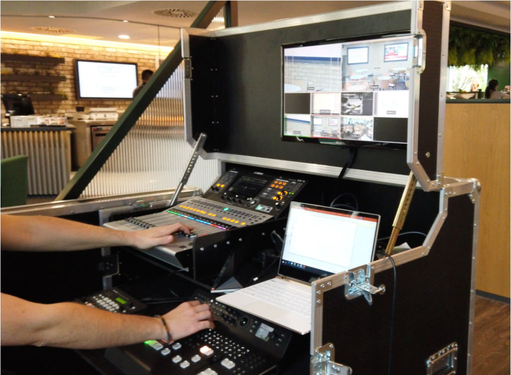 Someone using an AV mixer on site during a media production